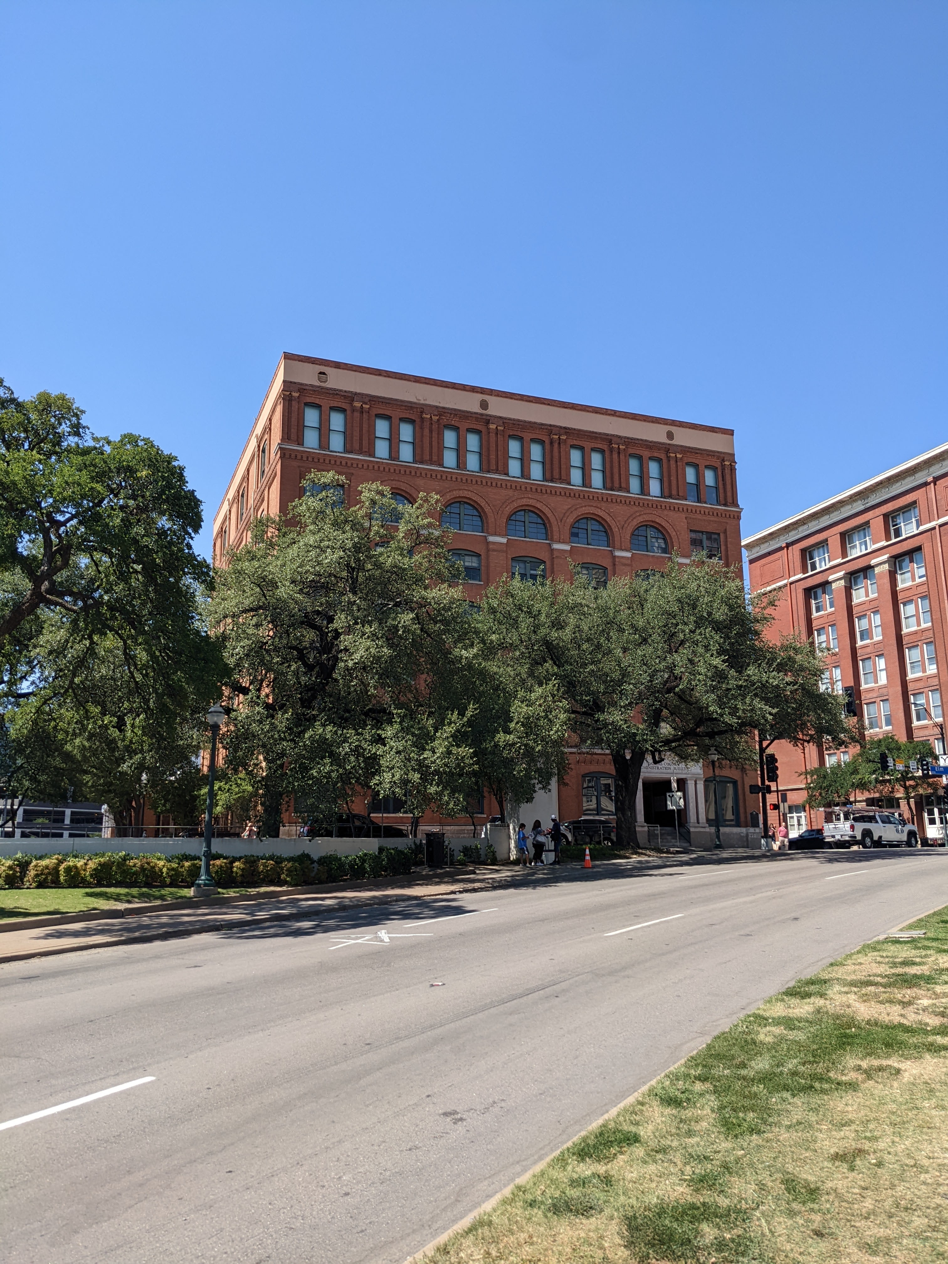 Former Texas School Book Depository Building and Elm Street, with an X marking the site of JFK's assassination